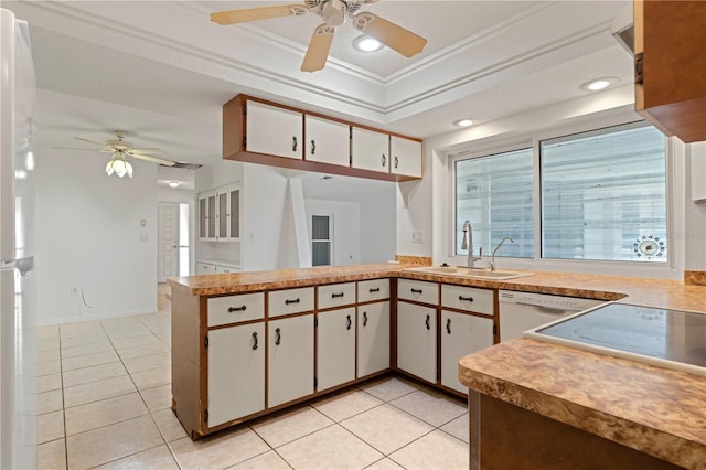 kitchen featuring white cabinets, sink, ornamental molding, light tile patterned flooring, and kitchen peninsula