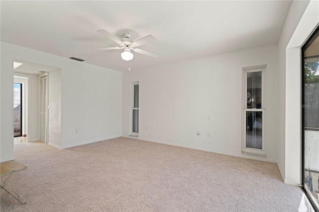 unfurnished room with ceiling fan and light colored carpet