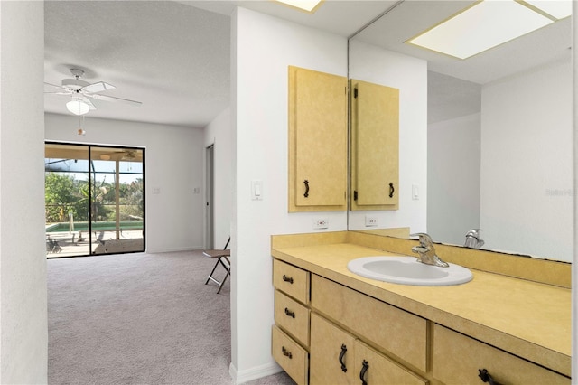 bathroom with ceiling fan and vanity