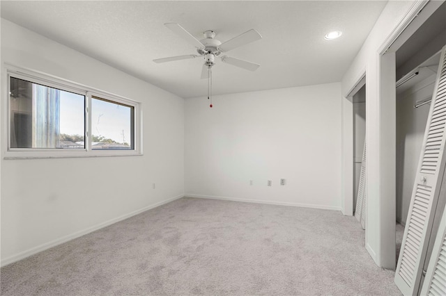 unfurnished bedroom featuring light carpet and ceiling fan