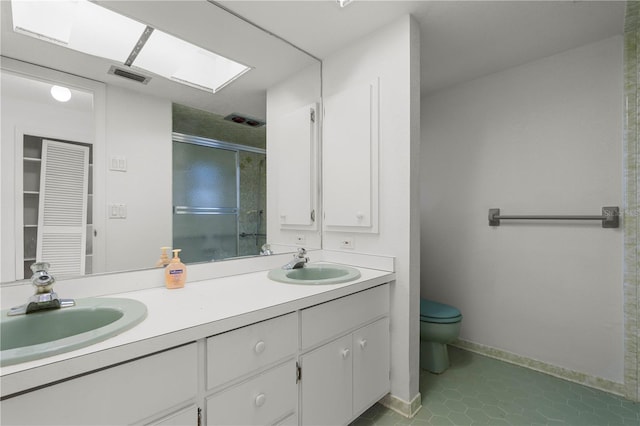 bathroom featuring walk in shower, tile patterned flooring, vanity, and toilet