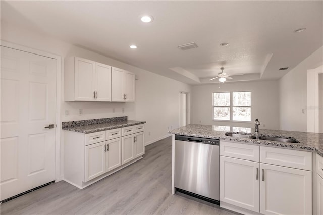 kitchen with stainless steel dishwasher, light hardwood / wood-style floors, white cabinets, and sink