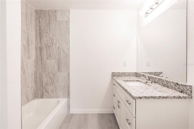 bathroom with vanity, wood-type flooring, and bathing tub / shower combination