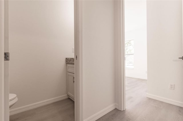 bathroom with vanity, hardwood / wood-style flooring, and toilet