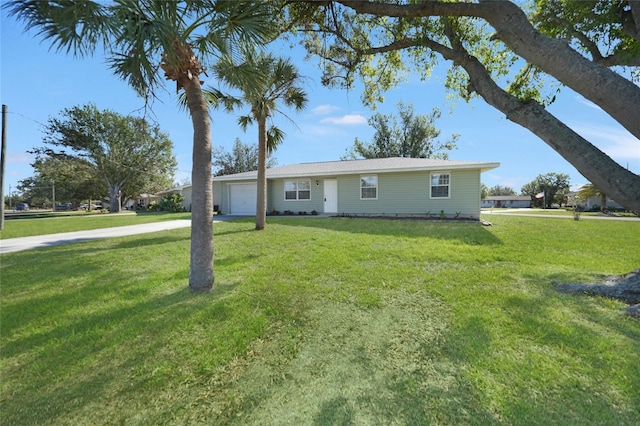 ranch-style home with a garage and a front lawn