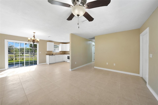 unfurnished living room featuring sink, ceiling fan with notable chandelier, and light tile patterned flooring