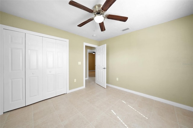 unfurnished bedroom featuring ceiling fan, a closet, and light tile patterned floors