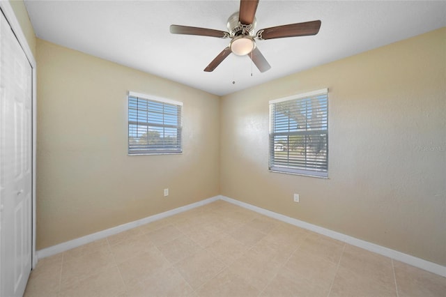 spare room featuring ceiling fan and light tile patterned flooring