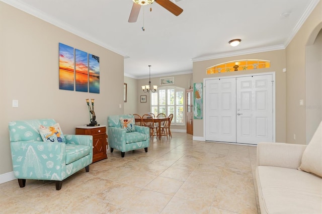 foyer entrance featuring crown molding, light tile patterned floors, and ceiling fan with notable chandelier