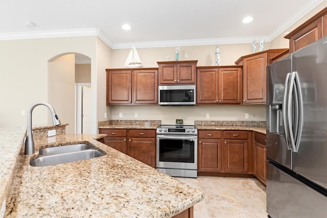 kitchen with crown molding, light stone countertops, sink, and appliances with stainless steel finishes