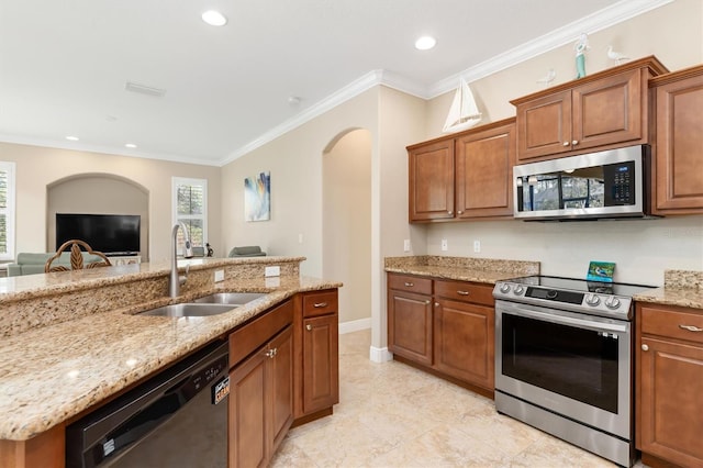 kitchen with crown molding, light stone countertops, sink, and appliances with stainless steel finishes