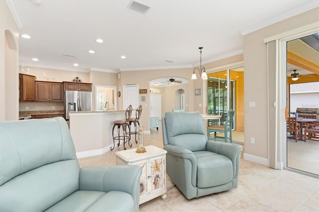 living room featuring crown molding and light tile patterned floors