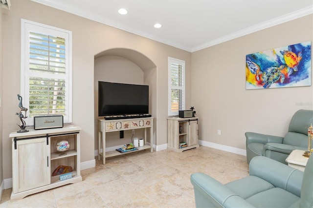 tiled living room with ornamental molding and a wealth of natural light