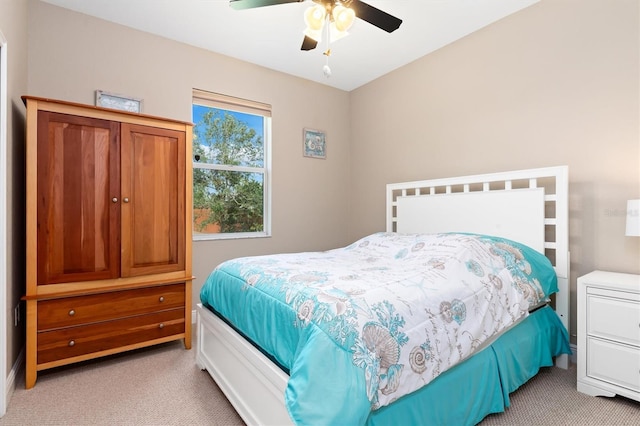 bedroom with ceiling fan and light colored carpet