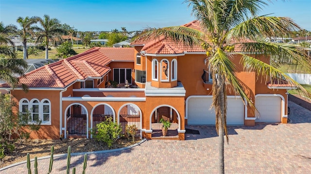 mediterranean / spanish-style house with a garage