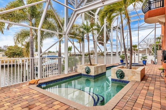 view of swimming pool featuring glass enclosure and a patio area