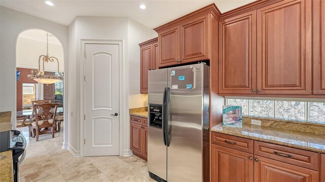 kitchen with pendant lighting, light stone countertops, stainless steel refrigerator with ice dispenser, and black range with electric cooktop