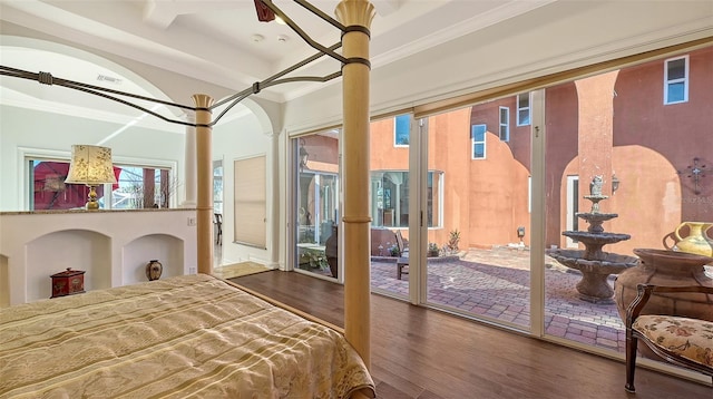 bedroom with wood-type flooring, access to outside, and ornamental molding