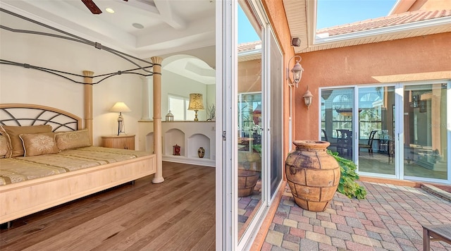 interior space featuring access to outside, a skylight, and hardwood / wood-style floors