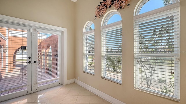 entryway featuring plenty of natural light and light tile patterned flooring