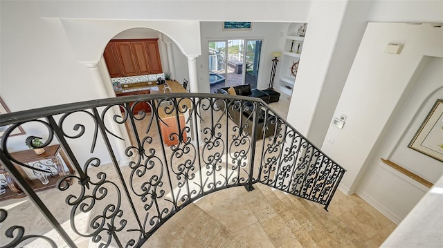 stairway featuring ornate columns