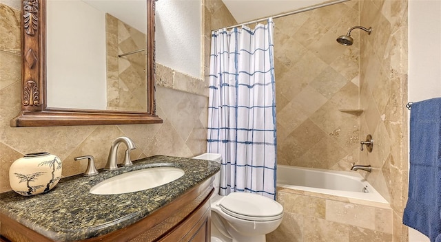 full bathroom with vanity, toilet, shower / bath combo with shower curtain, and tile walls