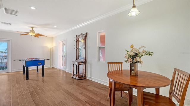 interior space featuring ceiling fan, light hardwood / wood-style floors, crown molding, and french doors