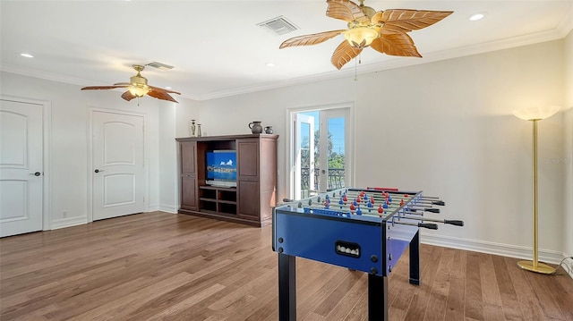 playroom featuring hardwood / wood-style flooring, ceiling fan, and crown molding