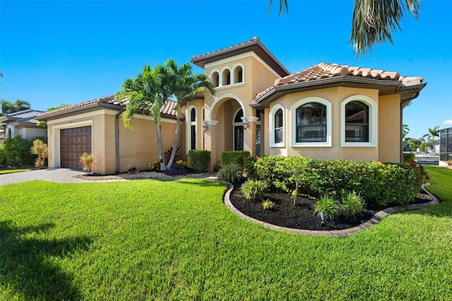 mediterranean / spanish home with a front yard and a garage