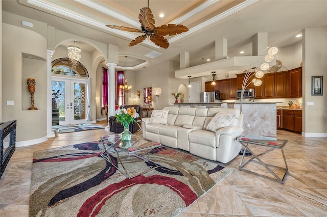 living room with french doors, a towering ceiling, a raised ceiling, and crown molding