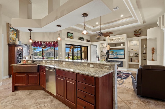 kitchen featuring pendant lighting, ceiling fan, a raised ceiling, and a spacious island