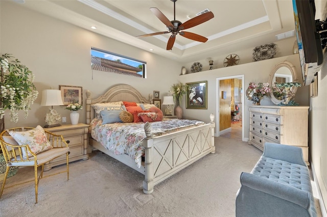 carpeted bedroom with a raised ceiling, ceiling fan, and ornamental molding