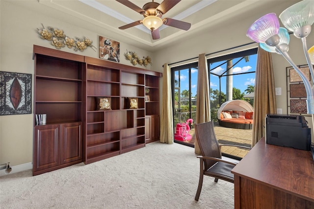 office with ornamental molding, light colored carpet, ceiling fan, and a tray ceiling