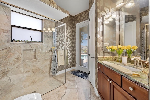 bathroom featuring tiled shower and vanity