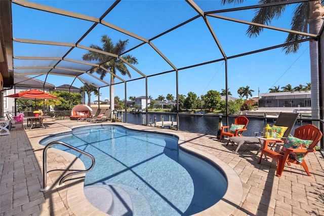 view of pool featuring a lanai, a patio area, and a water view