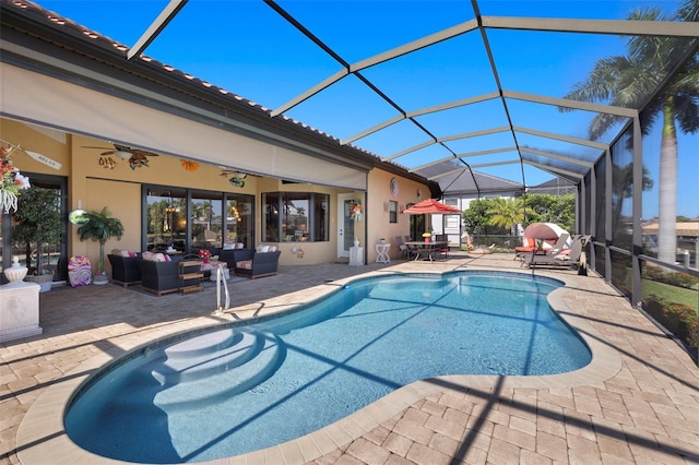 view of swimming pool with a lanai, ceiling fan, a patio, and an outdoor hangout area