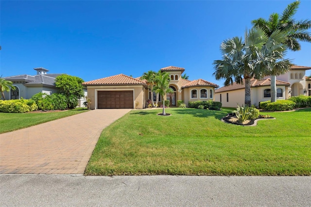 mediterranean / spanish-style house with a front yard and a garage