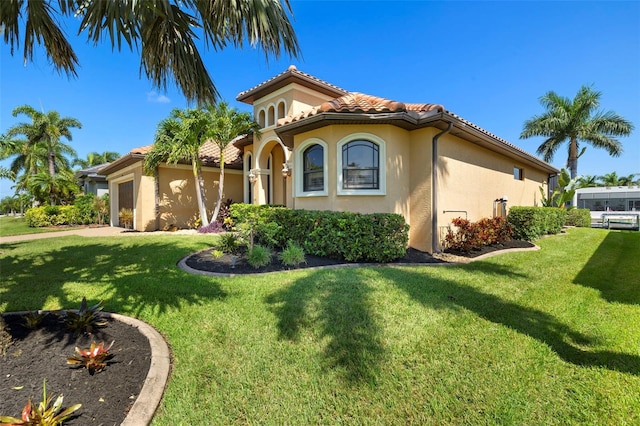 mediterranean / spanish-style home with a front yard