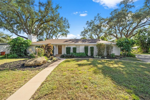 ranch-style home with a front lawn