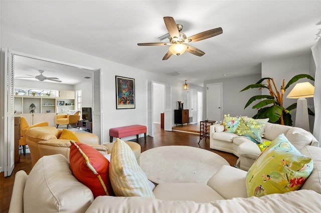 living room with dark hardwood / wood-style floors and ceiling fan