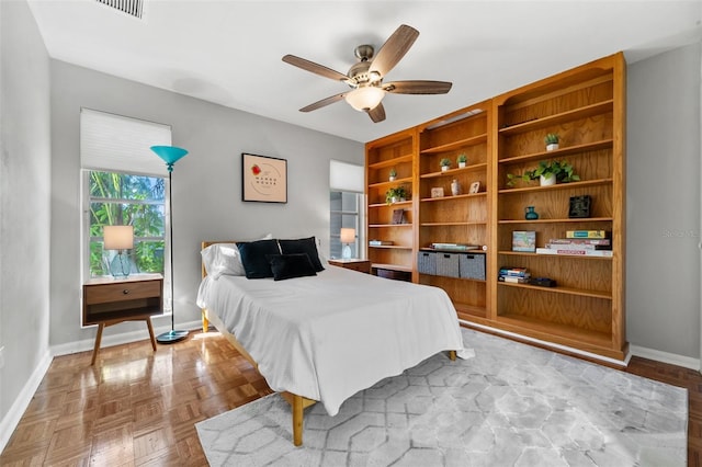 bedroom featuring ceiling fan and light parquet floors