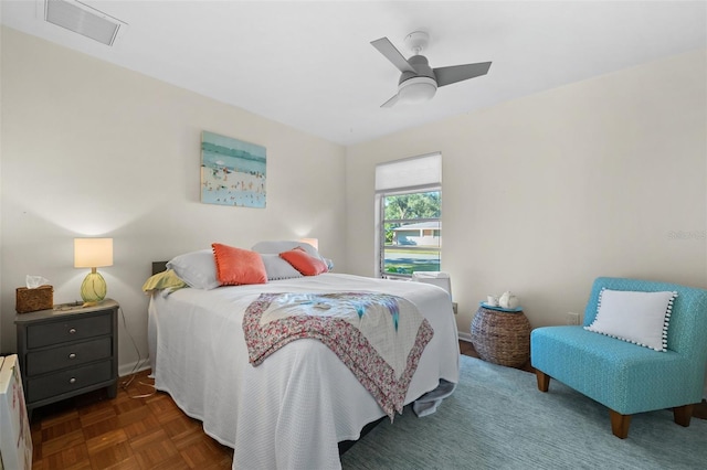 bedroom with ceiling fan and dark parquet floors