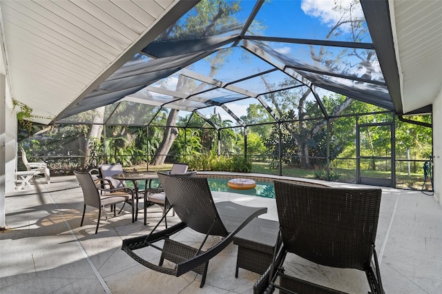 view of patio featuring glass enclosure