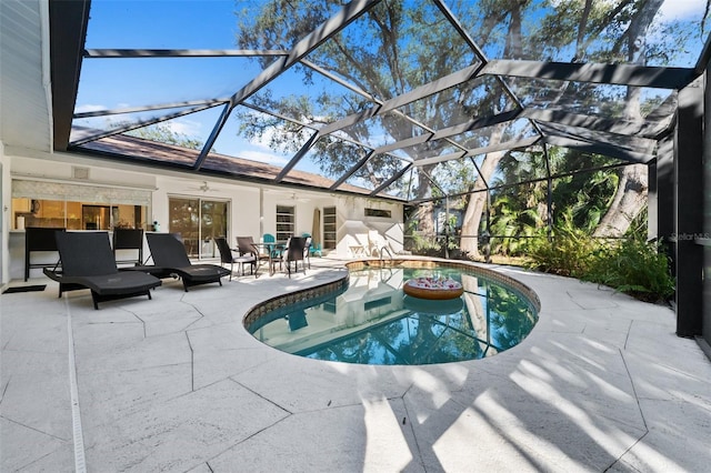 view of pool featuring a patio area, ceiling fan, and glass enclosure