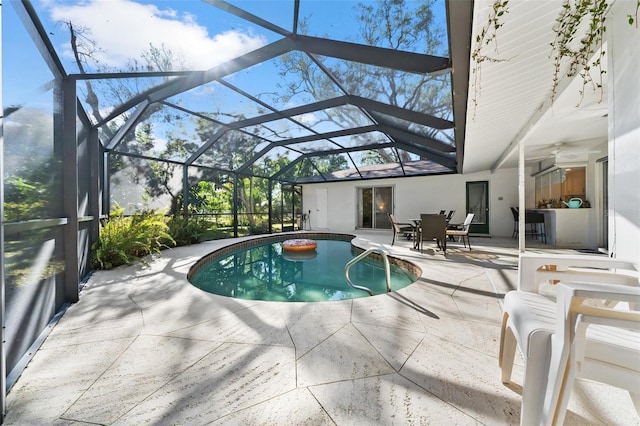 view of pool featuring glass enclosure and a patio area