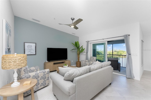 living room with ceiling fan and light tile patterned floors