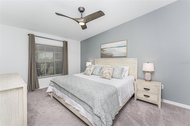 carpeted bedroom featuring ceiling fan and vaulted ceiling