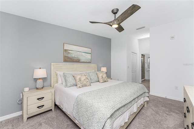 bedroom with ceiling fan, light carpet, and a closet