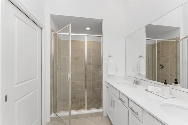 bathroom with tile patterned floors, vanity, and an enclosed shower