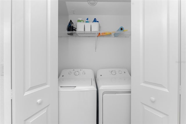 clothes washing area featuring washer and dryer